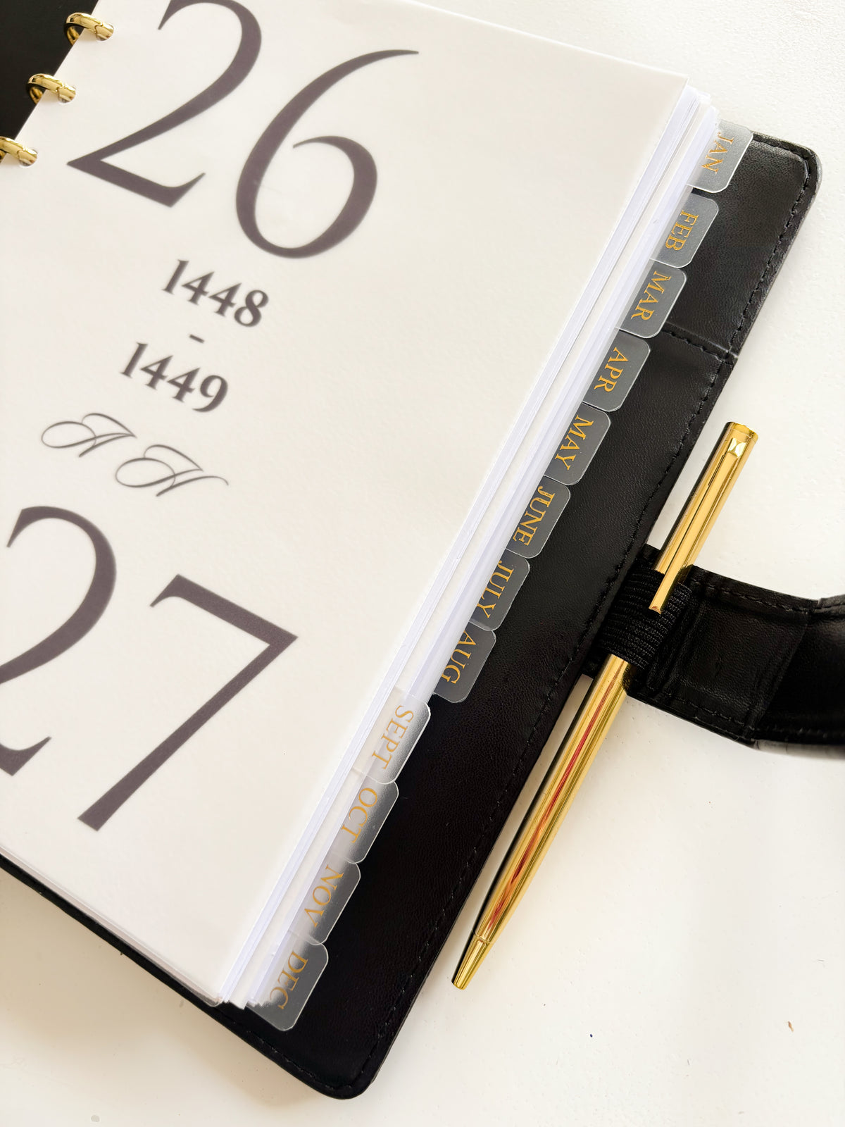 Monthly dividers inserted in a planner binder for easy organization