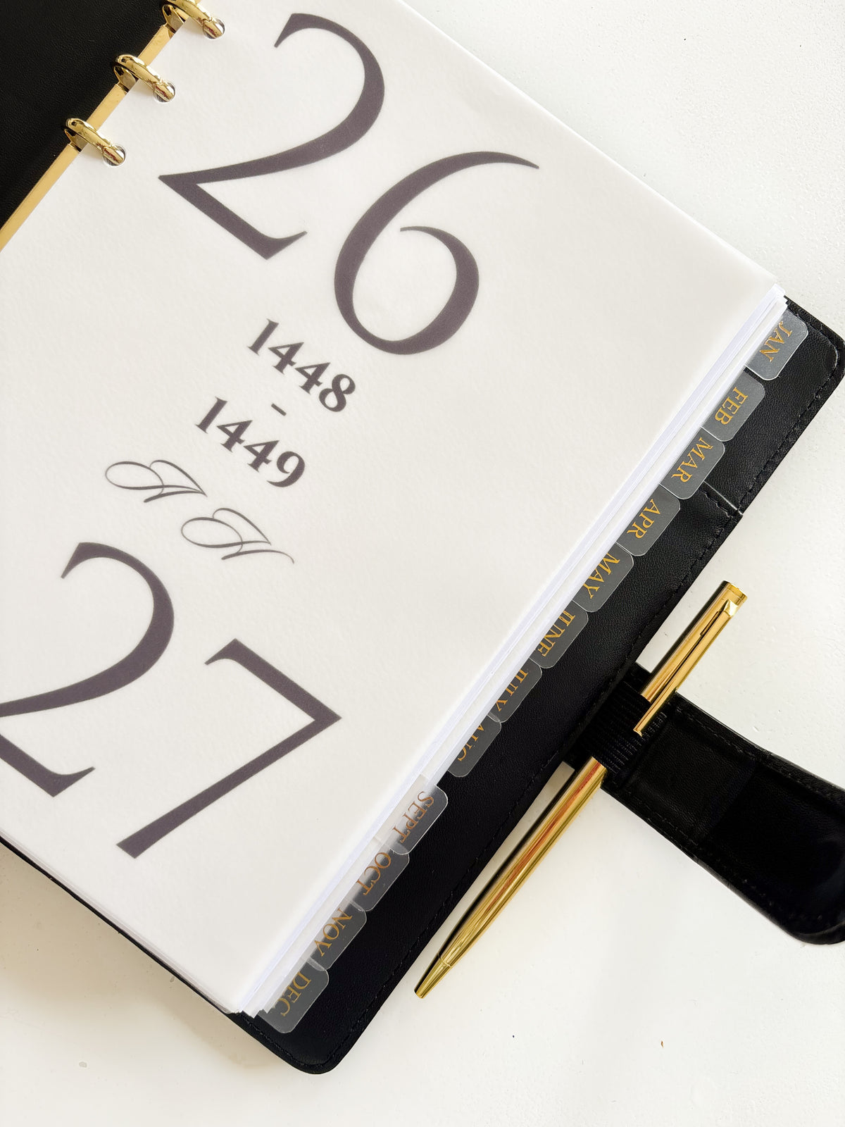 Monthly planner dividers for a planner binder with tabs for January through December